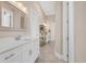 Bright bathroom featuring double vanity with white cabinets, modern fixtures, and a decorative gold shelving unit at 949 Crystal Water Way, Myrtle Beach, SC 29579