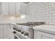 Modern kitchen boasting stainless steel stove and a bright subway tile backsplash at 949 Crystal Water Way, Myrtle Beach, SC 29579