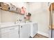 Bright laundry room with modern appliances and ample counter space at 949 Crystal Water Way, Myrtle Beach, SC 29579