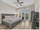 Well-lit main bedroom featuring hardwood floors and sliding glass door to the outside at 949 Crystal Water Way, Myrtle Beach, SC 29579