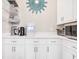 Well-organized pantry with white cabinetry, quartz countertops, and modern appliances at 949 Crystal Water Way, Myrtle Beach, SC 29579