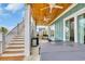 Covered patio featuring a wooden ceiling with fans, an outdoor kitchen, and stairs to the yard at 949 Crystal Water Way, Myrtle Beach, SC 29579