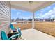 Covered back porch with seating area overlooking a serene community pond at 969 Oak Hollow St., Longs, SC 29568