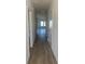 Bright hallway showcasing new wood flooring leading to living space and bedrooms at 969 Oak Hollow St., Longs, SC 29568