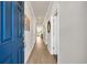 Bright hallway features wood-look flooring, neutral walls, and a striking blue front door at 969 Oak Hollow St., Longs, SC 29568