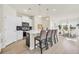 Bright kitchen featuring white cabinetry, stainless steel appliances, a breakfast bar, and an adjacent dining area at 969 Oak Hollow St., Longs, SC 29568