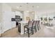 Modern kitchen with white cabinets, a breakfast bar, and stainless steel appliances at 969 Oak Hollow St., Longs, SC 29568