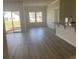Spacious living room with new vinyl flooring and sliding glass doors to the patio at 969 Oak Hollow St., Longs, SC 29568