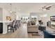 Bright, open-concept living space with modern furnishings and a view of the community pond at 969 Oak Hollow St., Longs, SC 29568