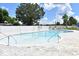 Community pool with zero entry access, lounge chairs, fence, and surrounding landscaping at 969 Oak Hollow St., Longs, SC 29568