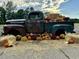 Rustic vintage truck bed overflowing with autumn décor, including pumpkins and vibrant fall flowers at 969 Oak Hollow St., Longs, SC 29568