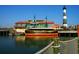 Waterfront view featuring a beautiful pier, restaurant, and lighthouse on a sunny day at 969 Oak Hollow St., Longs, SC 29568