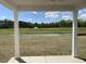 Covered patio overlooking a beautiful backyard with lush greenery and water at 990 Oak Hollow St., Longs, SC 29568
