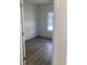 A bright bedroom showcasing a view of wood-look flooring and a window view at 990 Oak Hollow St., Longs, SC 29568