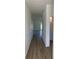 A light-filled hallway with wood floors leads to the living areas and bedrooms at 990 Oak Hollow St., Longs, SC 29568