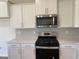 Kitchen with white cabinets, stainless steel appliances, and white countertops at 990 Oak Hollow St., Longs, SC 29568