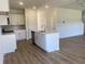 Bright kitchen boasts a central island, white cabinets, and modern stainless steel appliances at 990 Oak Hollow St., Longs, SC 29568