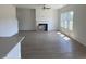 Spacious living room with a fireplace, light floors, and abundant natural light at 990 Oak Hollow St., Longs, SC 29568