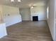 Spacious living room with a fireplace and wood flooring creates an inviting atmosphere at 990 Oak Hollow St., Longs, SC 29568