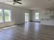 Bright living room featuring wood-look floors, large windows, and neutral paint at 990 Oak Hollow St., Longs, SC 29568