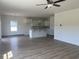 Open-concept living space showing the kitchen and living room with luxury vinyl flooring at 990 Oak Hollow St., Longs, SC 29568