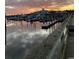 Sunset view of a marina filled with boats and docks, with a building silhouette in the distance at 990 Oak Hollow St., Longs, SC 29568