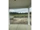 View from a porch overlooking a green space with newly planted grass beyond the property limits at 990 Oak Hollow St., Longs, SC 29568