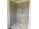 Tiled shower with a built-in niche and white shower pan at 990 Oak Hollow St., Longs, SC 29568