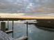 Scenic waterfront view of a marsh landscape with calm water, docks, and waterfront homes in the distance at twilight at 990 Oak Hollow St., Longs, SC 29568