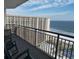 Relaxing balcony with comfortable chairs overlooking the ocean and nearby building at 100 North Beach Blvd. # 1917, North Myrtle Beach, SC 29582