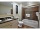 Well-lit bathroom featuring a granite vanity and a bathtub-shower combination enclosed with glass at 100 North Beach Blvd. # 1917, North Myrtle Beach, SC 29582