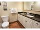 Bathroom featuring a double sink vanity with granite countertops, a toilet, and tile floors at 100 North Beach Blvd. # 1917, North Myrtle Beach, SC 29582