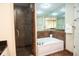 Bathroom with a walk-in shower, a bath tub, tile floors, and a mirror with a wood frame at 100 North Beach Blvd. # 1917, North Myrtle Beach, SC 29582