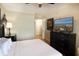 Bright bedroom featuring a dark dresser with a TV, a comfy bed, light-colored walls, and a ceiling fan at 100 North Beach Blvd. # 1917, North Myrtle Beach, SC 29582