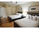 Inviting bedroom featuring two queen beds, dark wood furniture, neutral walls and wood-look laminate flooring at 100 North Beach Blvd. # 1917, North Myrtle Beach, SC 29582