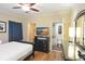 Comfortable bedroom with wood-look floors, TV, dresser and an open door to a nearby walk-in closet at 100 North Beach Blvd. # 1917, North Myrtle Beach, SC 29582