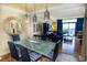 Bright living room with a glass-top table, chandelier and balcony access at 100 North Beach Blvd. # 1917, North Myrtle Beach, SC 29582