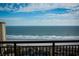 Serene ocean view with a sandy beach visible from a balcony with a metal railing at 100 North Beach Blvd. # 1917, North Myrtle Beach, SC 29582