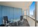 Inviting balcony featuring a table and chairs overlooking the distant beach at 1000 N Waccamaw Dr. # 205, Murrells Inlet, SC 29576