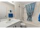 Bathroom with vanity, mirror, and tub with blue-patterned shower curtain at 1000 N Waccamaw Dr. # 205, Murrells Inlet, SC 29576
