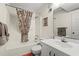 Bathroom with tub, patterned shower curtain, and sink with mirror at 1000 N Waccamaw Dr. # 205, Murrells Inlet, SC 29576