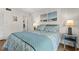 Inviting bedroom features a bed with blue linens and beach-themed decorations at 1000 N Waccamaw Dr. # 205, Murrells Inlet, SC 29576