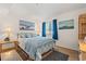Bedroom with blue decor, bamboo furniture, and boat-themed artwork at 1000 N Waccamaw Dr. # 205, Murrells Inlet, SC 29576