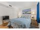 Comfortable bedroom with queen bed, TV, and bamboo nightstands at 1000 N Waccamaw Dr. # 205, Murrells Inlet, SC 29576