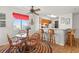 Cozy dining area with a round table, wicker chairs, and a view of the kitchen with bar stool seating at 1000 N Waccamaw Dr. # 205, Murrells Inlet, SC 29576