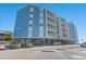 Angle view of a charming multifamily condo on a sunny day, with ample parking and an inviting atmosphere at 1000 N Waccamaw Dr. # 205, Murrells Inlet, SC 29576