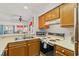 Galley kitchen featuring wood cabinets and bright countertops at 1000 N Waccamaw Dr. # 205, Murrells Inlet, SC 29576