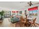 Bright living room boasts plush furnishings and a cozy dining area with balcony access and scenic views of the exterior at 1000 N Waccamaw Dr. # 205, Murrells Inlet, SC 29576