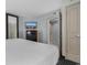 Well lit bedroom with chest of drawers, TV, ensuite and closet at 107 S Ocean Blvd. # 1002, Myrtle Beach, SC 29577