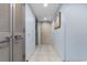 Long hallway featuring overhead lighting and beige-colored tile flooring at 107 S Ocean Blvd. # 1002, Myrtle Beach, SC 29577